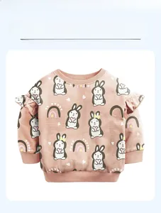 Detail of ruffle shoulder design on pink cotton toddler sweatshirt with rabbit print