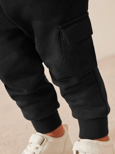 Boys black cargo joggers with side flap pockets and ribbed cuffs for casual autumn wear