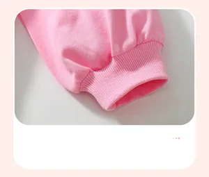 Detail of pink long sleeve ribbed cuff showing cotton fabric texture and stitching