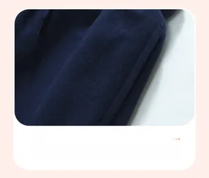 Detailed view of side pocket on navy blue knit boys' trousers with premium stitching
