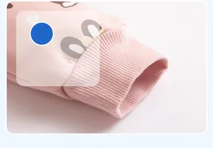 Close-up of pink cotton jacket ribbed cuff with soft cartoon rabbit pattern design