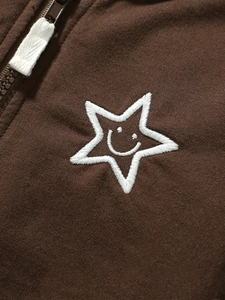 Brown toddler hoodie with white embroidered stars and smiley faces, zip closure detail