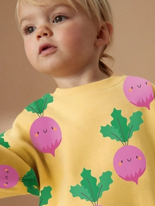 Girl's lemon yellow cotton sweatshirt featuring an all-over purple vegetable print