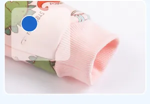 Detail of ribbed cuffs on pink cotton kids jacket with colorful dinosaur print patterns