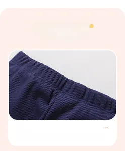 Close-up of dark blue ribbed knit pants showing the elastic waist and fabric texture