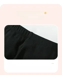 Detail of elastic ribbed waistband on girls' cotton leggings for comfortable fit