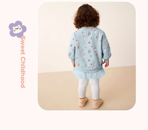 Back view of girl's blue Christmas sweater dress with tulle hem and festive prints