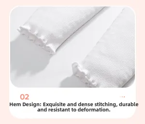 Detailed macro view of white ribbed knit leggings featuring elegant lettuce edge cuffs