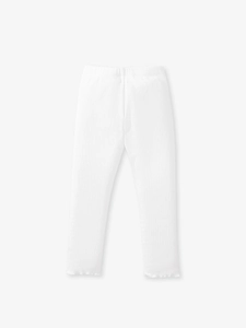 White ribbed cotton leggings for girls with decorative ruffled hem on light grey background