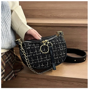 Detail view of tweed half-moon bag with gold chain and woven fabric texture