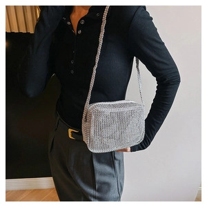 Detailed view of shiny silver rhinestone crossbody bag with elegant chain strap and zip closure