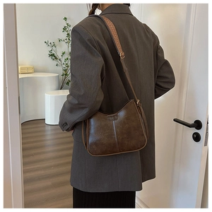 Détail du sac bandoulière vintage marron avec similicuir et sangle à motifs chic