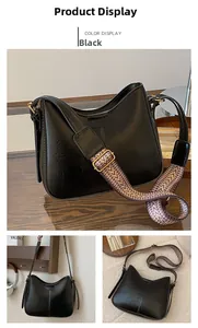 Detail of black leather hobo bucket bag with geometric wave pattern wide strap