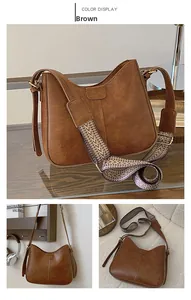 Detail of brown vintage bucket bag with bohemian jacquard strap and smooth PU leather