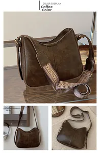 Detail view of coffee brown vintage hobo bag with geometric patterned wide shoulder strap