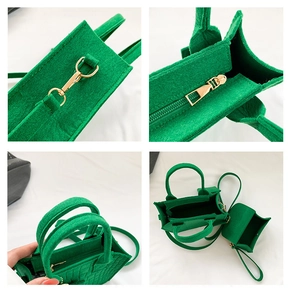 Vista de detalles del bolso de fieltro verde con cremalleras doradas y ganchos