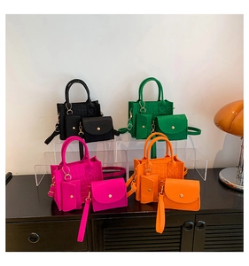 Detailed set of vibrant textured leather tote bags in four colors on a display stand