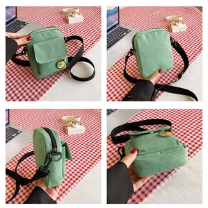 Detailed four-way view of green canvas crossbody bag with orange badge on checkered cloth