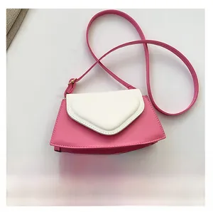 Pink heart-shaped crossbody bag shown next to a smartphone for size scale comparison