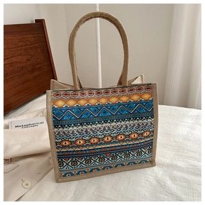 Detailed view of canvas tote bag with ethnic geometric pattern and woven texture