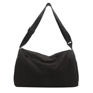 Minimalist black nylon crossbody bag with wide adjustable strap and large capacity