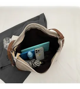 Deep interior of the large beige tote bag showing spacious storage for tablets and umbrellas