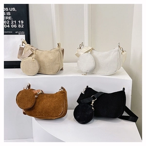 Detail of four corduroy crescent bags in beige, white, brown, and black with coin purses