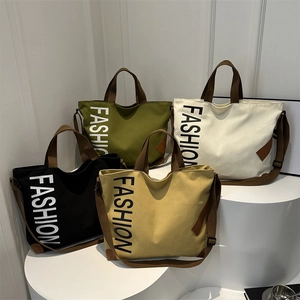Sac Fourre-Tout en Toile de Grande Capacité à la Mode pour Femmes Sac à Bandoulière Décontracté avec Lettres Imprimées Sac à Main Polyvalent pour le Travail avec Accents en Cuir
