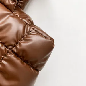 Macro shot of dark brown quilted puffer fabric showing neat diamond stitching and glossy finish