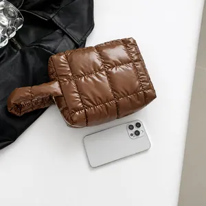 Detailed view of brown quilted puffer tote bag with high-shine finish and 45-degree angle
