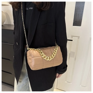 Close-up of khaki quilted leather bag with chunky gold chain handle and slim shoulder strap