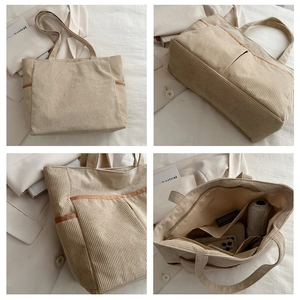 Detail view of large beige corduroy tote bag with brown trim and multiple pockets