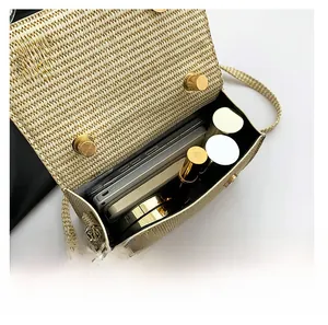 Interior view of beige woven crossbody bag showing storage for phone and cosmetics