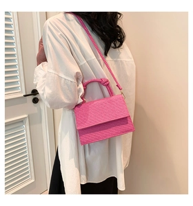 Detail of rose pink woven texture crossbody bag with unique knot handle design