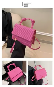 Detail of rose red woven texture handbag with unique knot handle and adjustable strap