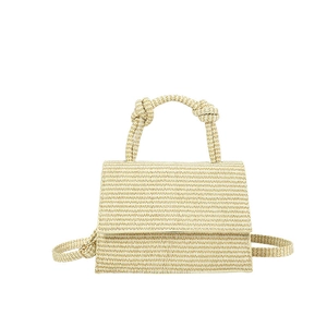 Minimalist woven straw crossbody bag with stylish knotted handles and a rectangular flap