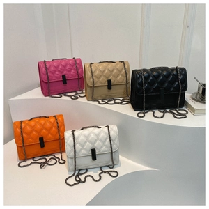 Bolsos bandolera acolchados con cadena en varios colores sobre pedestales blancos