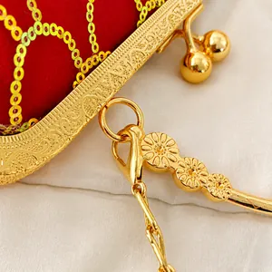 Macro shot of gold engraved floral metal hook and red sequin embroidery bag detail