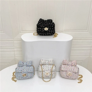 Mini tweed crossbody bag with bow accent and gold chain strap in four assorted colors