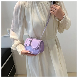 Close-up of lavender mini crossbody saddle bag with wave flap and silver chain strap