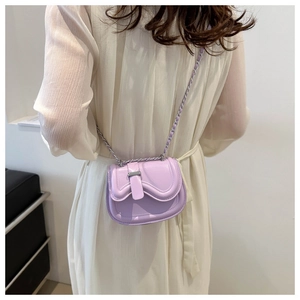 Detailed back view of a purple mini leather crossbody bag with woven chain strap and wavy flap