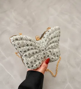 Detalle del bolso de noche mariposa con lentejuelas plateadas y cadena dorada