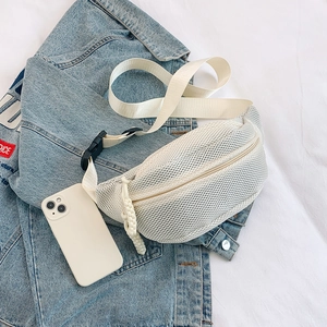 Detailed shot of white mesh chest bag with adjustable strap and buckle on denim background