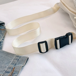Detail of adjustable nylon shoulder strap and quick-release buckle on mesh crossbody bag