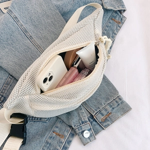 Detailed view of white mesh chest bag showing spacious interior with personal essentials