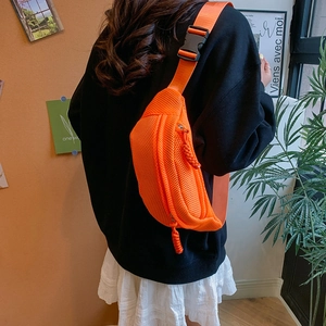 Detail of bright orange mesh chest bag with breathable fabric and adjustable strap