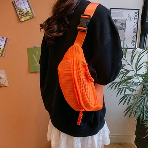 Detail of orange mesh crossbody bag with dual zippers and adjustable buckle strap