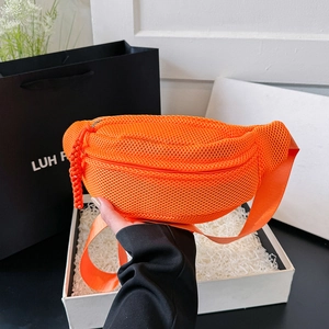 Detail of bright orange mesh waist bag with honeycomb texture and woven zipper pull