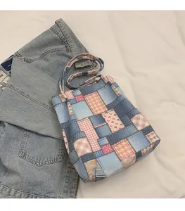 Detailed patchwork denim tote bag with blue floral and pink plaid patterns