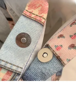 Detail shot of the secure magnetic silver buckle on floral print canvas tote bag